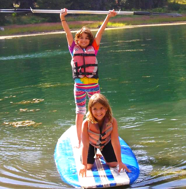 Two kids on a paddleboard