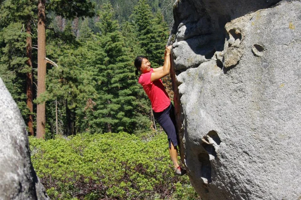 A camper climbing up a rock