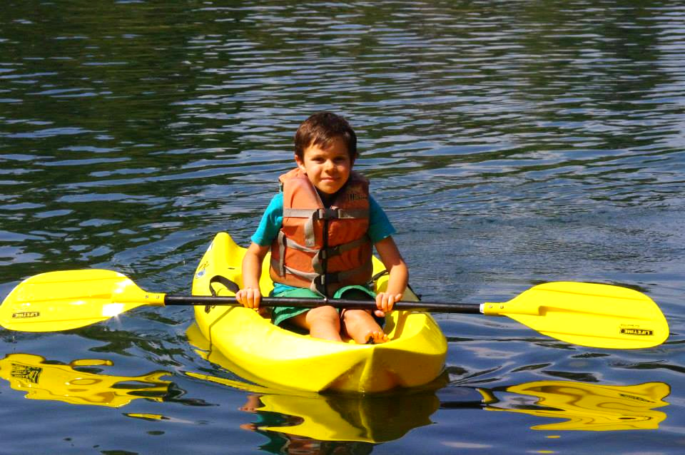 A kid kayaking at the lake