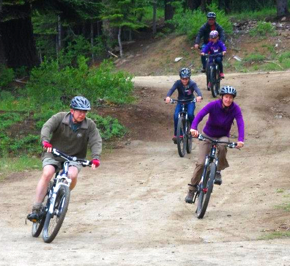 Five bikers riding a trail