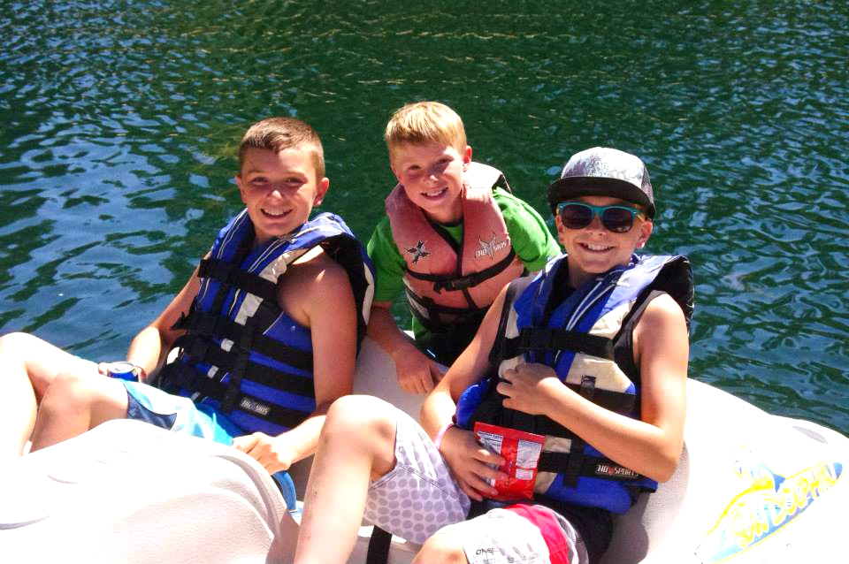 Three children on a paddle boat