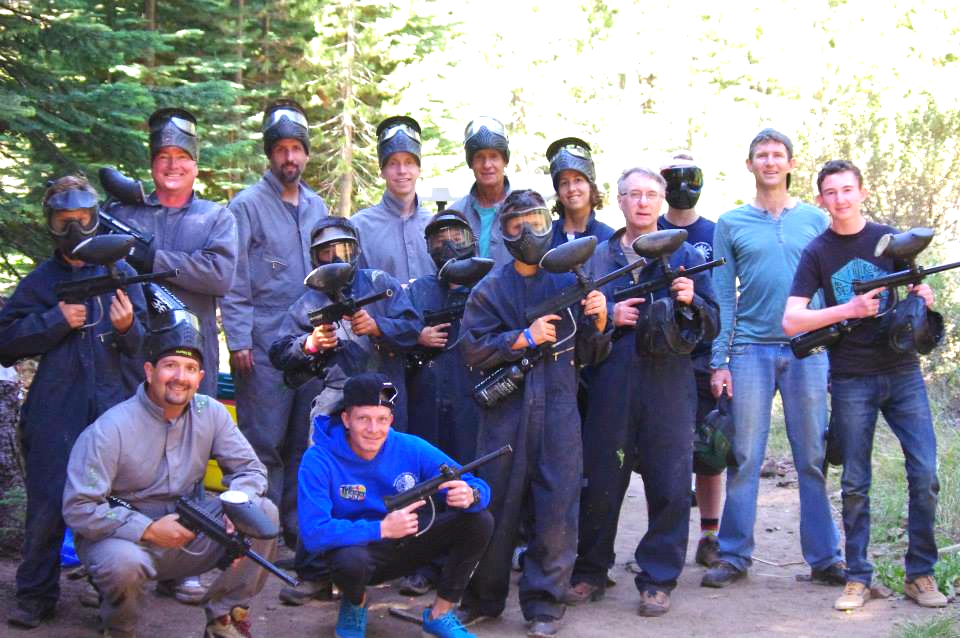 A group holding paintball guns, preparing to start a game